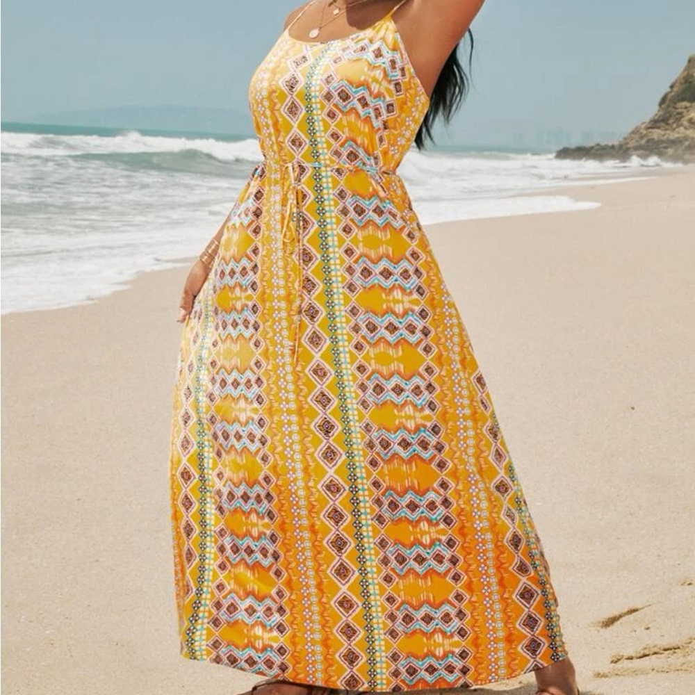Beautiful flowy dress. Has string that matches to tie around middle.